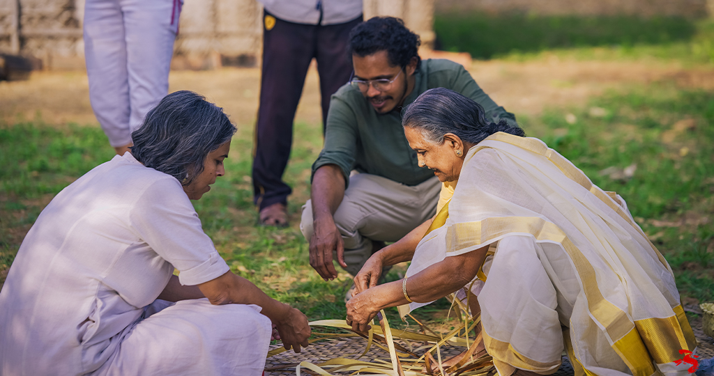 A traveler trying her hand at mat weaving in Palakkad.